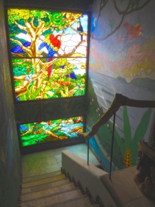 Staircase stained glass window and mural of Pavones.