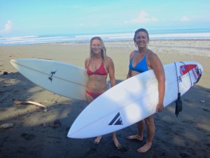 Aloe and Michelle surfing near Pavones, Costa Rica.
